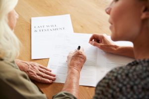 Attorney Helping Senior Woman To Complete Last Will And Testament
