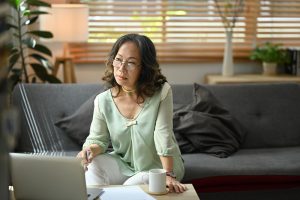 Mature woman researching attorneys on computer