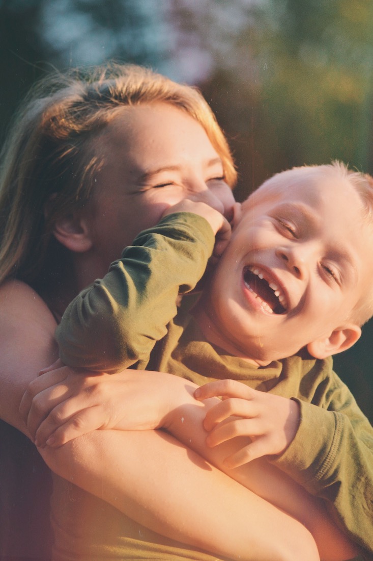 Child Custody in MN. Brother and sister smiling and laughing.