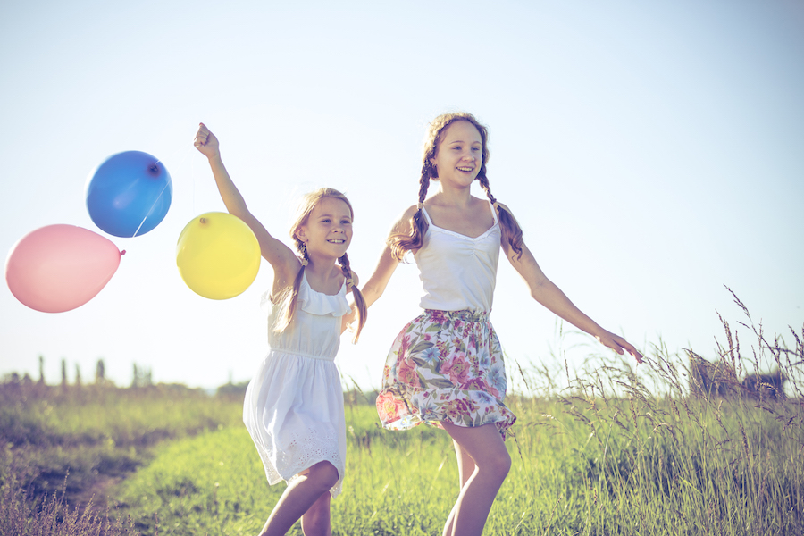 Child custody in MN. Happy little children playing in the field at the day time.