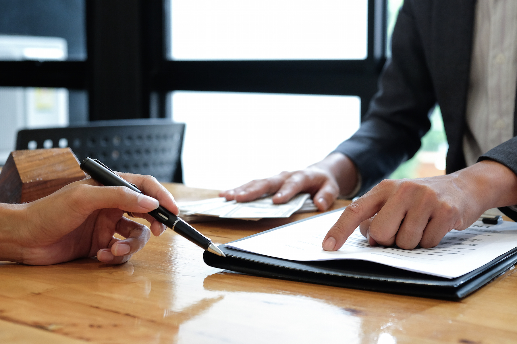 Divorce agreement. divorcees pointed to signing agreement documents.