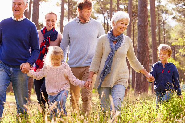 Happy multi-generation family walking in the countryside