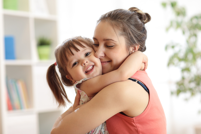 parent hugging child - child protection