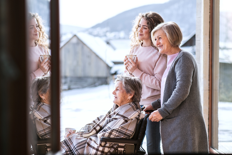 A teenage girl with her mother and grandmother in wheelchair at home. Estate Planning