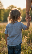 child holding hand of father